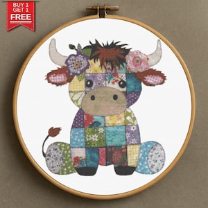 May include: A colorful cross-stitch of a patchwork cow in a wooden embroidery hoop. The cow has a floral crown and is made of various patterned squares in shades of purple, blue, green, and red. The text "BUY 1 GET 1 FREE" is in the upper left corner.