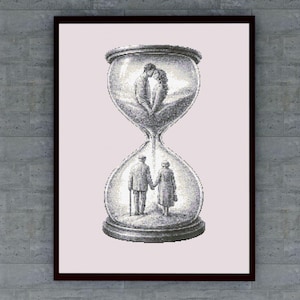 May include: Framed artwork depicting an hourglass with two couples inside. The top half shows a young couple kissing, while the bottom half shows an elderly couple holding hands. The artwork is in black and white with a gray background.