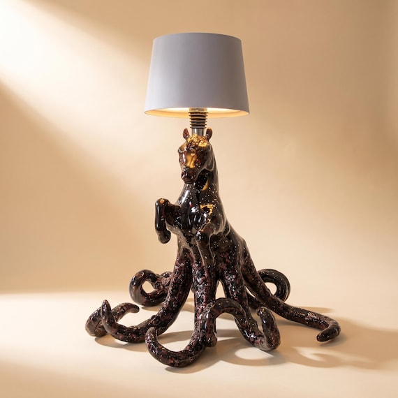 A surrealist horse head emerging from the lamp base — handmade ceramic sculpture that functions as bold statement lighting.