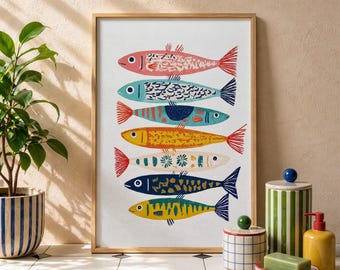 May include: A framed art print featuring a colorful illustration of seven stylized fish. Each fish has a unique pattern and color, including pink, blue, yellow, and green, with red tail fins. The artwork is displayed on a white background.