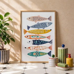 May include: A framed art print featuring seven stylized fish in various colors, including pink, blue, yellow, and orange. Each fish has unique patterns and designs. The artwork is displayed on a white background.