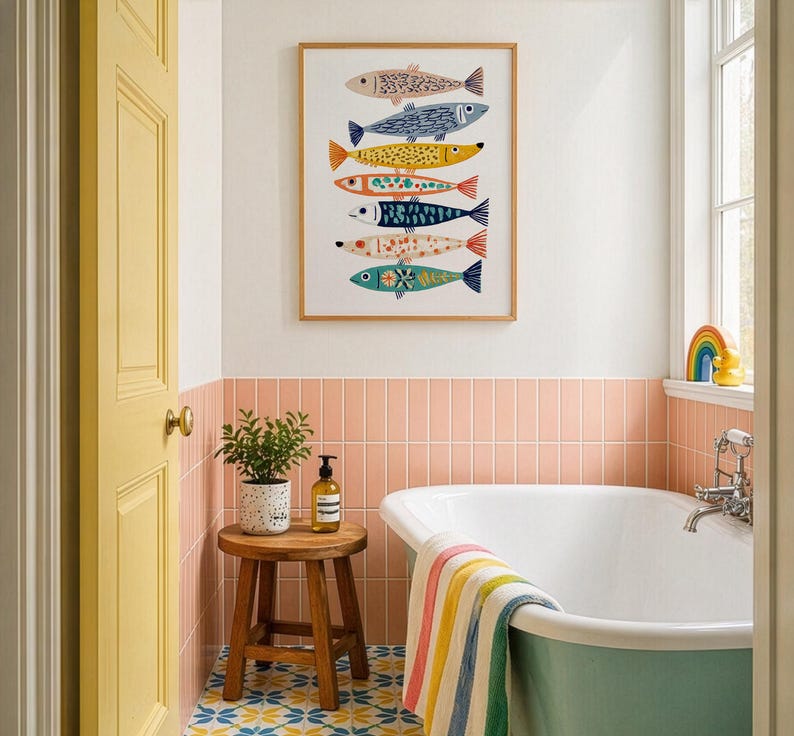 May include: A framed art print featuring seven colorful fish illustrations. The fish are in various colors and patterns, including blue, yellow, and orange. The artwork hangs above a bathtub with a colorful striped towel. A small wooden stool holds a plant and soap.