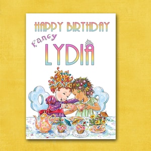 May include: Happy Birthday Fancy Lydia card featuring two girls in pink and purple dresses having tea with cupcakes. The card has a white background with a pink and blue border.