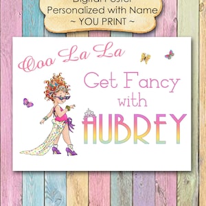 May include: A digital printable poster featuring a cartoon girl with red curly hair wearing sunglasses and a colorful dress. The text on the poster reads "Ooo La La Get Fancy with AUBREY".