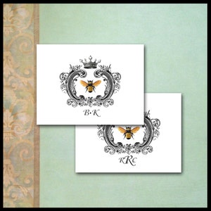 May include: Two white cards with black and gold bee and crown designs. The top card has the initials "B.K." and the bottom card has the initials "R.R.C."