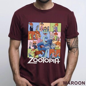 Peut inclure: T-shirt bordeaux avec un collage color&eacute; de personnages du film d'animation "Zootopie". Le motif comprend le titre du film en lettres blanches. Le t-shirt est &agrave; manches courtes et a un col rond.