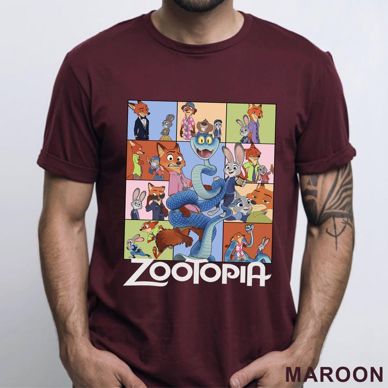 Peut inclure: T-shirt bordeaux avec un collage color&eacute; de personnages du film d'animation "Zootopie". Le motif comprend le titre du film en lettres blanches. Le t-shirt est &agrave; manches courtes et a un col rond.