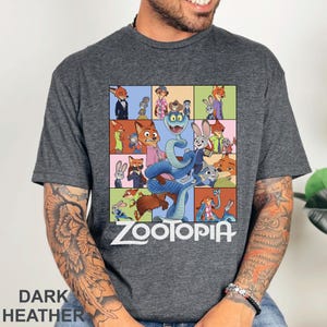 Peut inclure: T-shirt gris chin&eacute; fonc&eacute; avec un graphisme color&eacute; des personnages du film d'animation Zootopie. Le motif comprend une grille d'images avec le mot "Zootopia" en blanc. Le t-shirt est fait d'une mati&egrave;re douce.