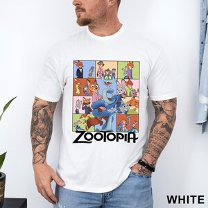 Peut inclure: T-shirt blanc avec un motif color&eacute; du film d'animation "Zootopie". Le design pr&eacute;sente divers personnages dans une grille, avec le titre du film en noir. Le t-shirt est de style col rond classique.