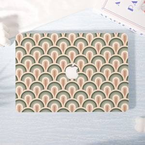 May include: A laptop cover featuring a repeating pattern of arched shapes in shades of green, brown, and beige. The Apple logo is visible in the center. The cover has a retro, art deco style.