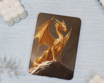 May include: A rectangular case featuring a golden dragon illustration. The dragon is depicted with outstretched wings, perched on a rock. The background is a blend of brown and grey. The case has rounded corners.