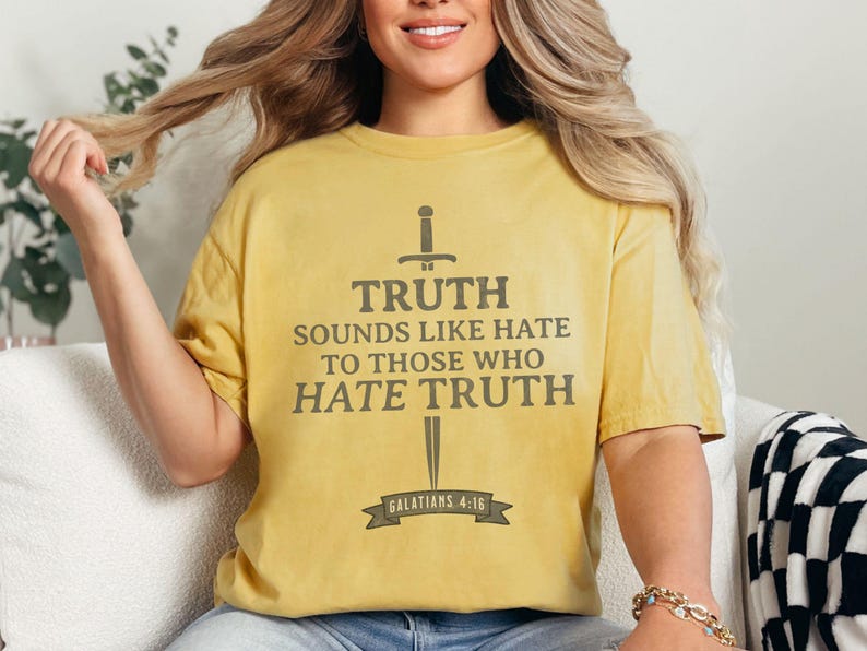 May include: Mustard yellow t-shirt with the text "TRUTH SOUNDS LIKE HATE TO THOSE WHO HATE TRUTH" in gray, with a sword graphic. The text includes the reference "GALATIANS 4:16".