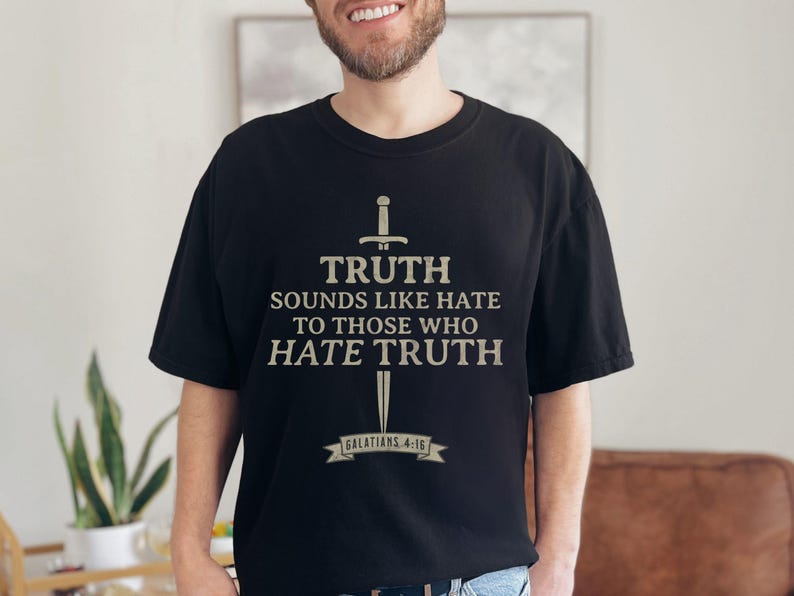 May include: Black t-shirt with a sword graphic and the text "TRUTH sounds like hate to those who hate truth" and "Galatians 4:16". The shirt is made of a soft material.