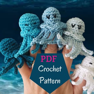 May include: A hand wearing five crocheted octopus finger puppets. The octopus finger puppets are blue, light blue, and white. The text "PDF Crochet Pattern" is on a blue background.