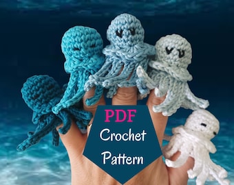 May include: A hand wearing five crocheted octopus finger puppets. The octopus finger puppets are blue, light blue, and white. The text "PDF Crochet Pattern" is on a blue background.