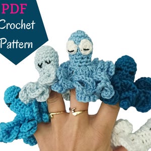 May include: A set of five crocheted octopus finger puppets in shades of blue and white. The puppets are worn on a person's fingers.