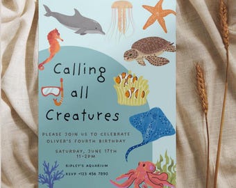 May include: A light blue invitation with sea creature illustrations, including a dolphin, jellyfish, starfish, turtle, and octopus. The text reads "Calling all Creatures" and invites guests to a birthday party at Ripley's Aquarium.