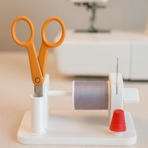 May include: A set of three ceramic mugs with a speckled, matte finish. The mugs are in shades of cream, light brown, and dark brown. Each mug has a simple, minimalist design, perfect for coffee or tea.