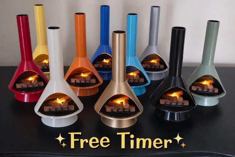 May include: A selection of brightly coloured, retro-style tabletop fireplaces. Each fireplace is a different colour, including red, yellow, orange, blue, gold, teal, grey, black, and green. The fireplaces have a flame effect inside. The text "Free Timer" is at the bottom.