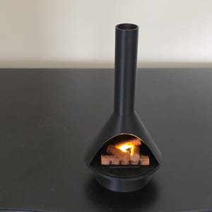 May include: A black, mid-century style fireplace with a tall chimney and a conical base. The fireplace has a glowing fire inside, with wooden logs and a warm, inviting light.