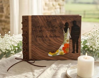 May include: A wooden wedding album with a laser-cut design of a bride and groom holding hands. The album cover features the names "Emily & Stephen" and the year "EST 2026", along with the quote "I wish I knew how to quit you, You complete me."
