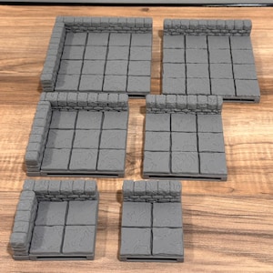 May include: Five gray stone tile dungeon floor sections with stone walls. Each section is a square with a 3x3 grid of tiles. The tiles have a textured surface.