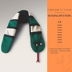 May include: A green, white, and black snake-shaped sewing pattern. The snake has a red tongue and silver eyes. The text on the right says "ENRICHMENT SNAKE SEWING PATTERN" and includes "PDF FILE (READY TO PRINT)" and "DETAILED INSTRUCTIONS INCLUDED."
