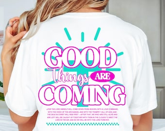May include: White t-shirt with the words "GOOD Things ARE COMING" in a teal and pink design. The shirt also includes a Bible verse in a smaller font below the main text.