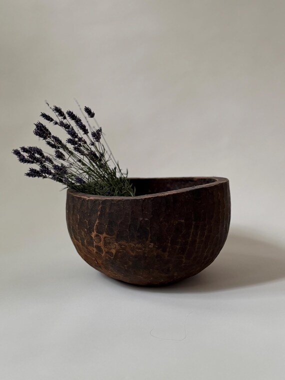 A genuine antique Naga tribal dough bowl hand-carved in India — the kind of rustic artifact that anchor-styles an entire room and has an actual history behind it.