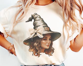 May include: Cream-colored sweatshirt featuring a detailed illustration of a woman wearing a witch hat with a lace bow. The artwork showcases the woman's face and wavy hair, set against a neutral background. The design is perfect for Halloween or anyone who loves witchy aesthetics.