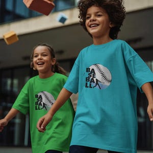 May include: A bright turquoise short-sleeved t-shirt and a vibrant green short-sleeved t-shirt, each featuring a graphic of a white baseball with black stitching and the word BASEBALL printed in black, accompanied by a silhouette of a batter.
