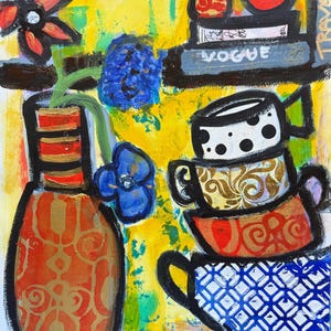 May include: Abstract painting with a yellow background featuring a vase with flowers, stacked teacups, and a shelf with books. The teacups have various patterns, including polka dots and floral designs. The word "VOGUE" is visible on a book.