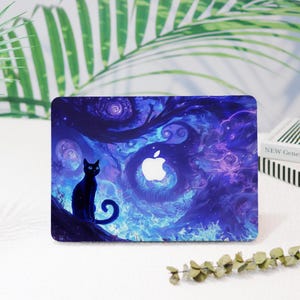May include: A black cat silhouette sits on a branch in front of a swirling blue and purple galaxy background. The background has a white apple logo in the center. This is a laptop skin.