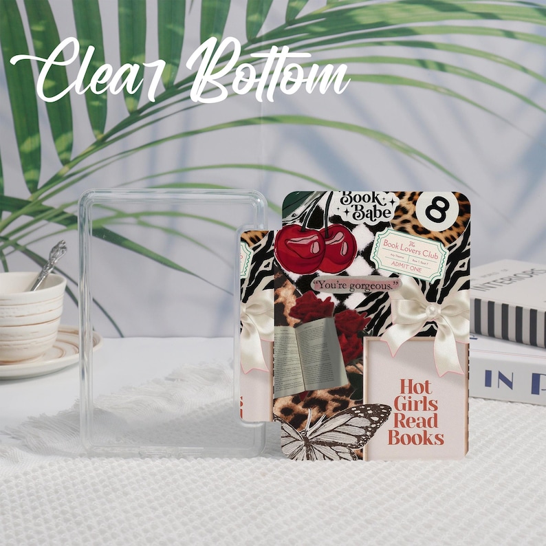 May include: A clear, rectangular phone case with the text "Clear Bottom" in a cursive font. A decorative card features cherries, a butterfly, and the text "Hot Girls Read Books". The card has a zebra print and a leopard print.