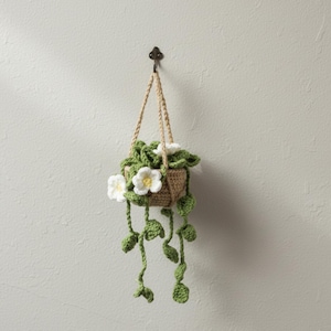 Crochet pot with yellow flowers and green vines handmade