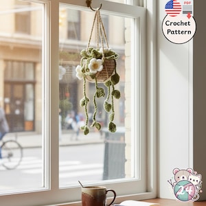 Crochet charm mini potted plant with green leaves on a window handmade decor
