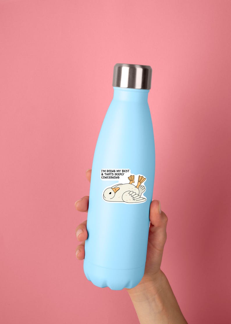 May include: A light blue insulated water bottle with a silver lid. A sticker on the bottle features a cartoon duck with the text "I'M DOING MY BEST & THATS DEEPLY CONCERNING."