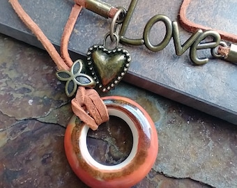 One-of-a-kind brick red ceramic donut pendant with antique gold embelishments