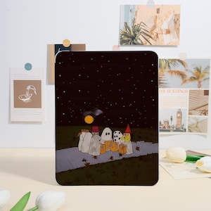 May include: A rectangular Halloween-themed print featuring a group of costumed figures trick-or-treating under a starry night sky. The figures include ghosts, a witch, and a person in a hat, all holding treat bags. The print has a dark color palette with a full moon.