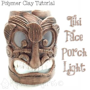 May include: A brown tiki face porch light made from polymer clay. The face has a carved wooden texture and features two large eyes, a wide mouth, and a prominent nose.