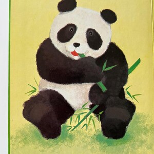 May include: A colourful illustration from a children's book, showing a panda bear with black and white fur, eating bamboo. The background is yellow-green, with the text "Once there was a little panda".