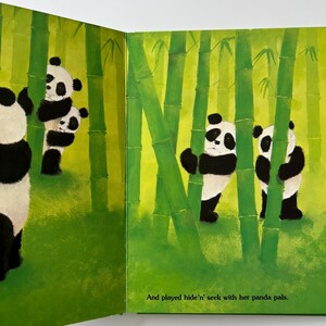 May include: An illustrated children's book spread showing panda bears in a bamboo forest. The pandas are black and white, and the bamboo is green. The text reads, "And played hide 'n' seek with her panda pals."
