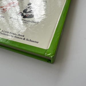 May include: A children's book titled "The Little Panda Bear" with a green border. The cover features a panda illustration and other animal characters. Published by Simon & Schuster, part of the Little Simon series.