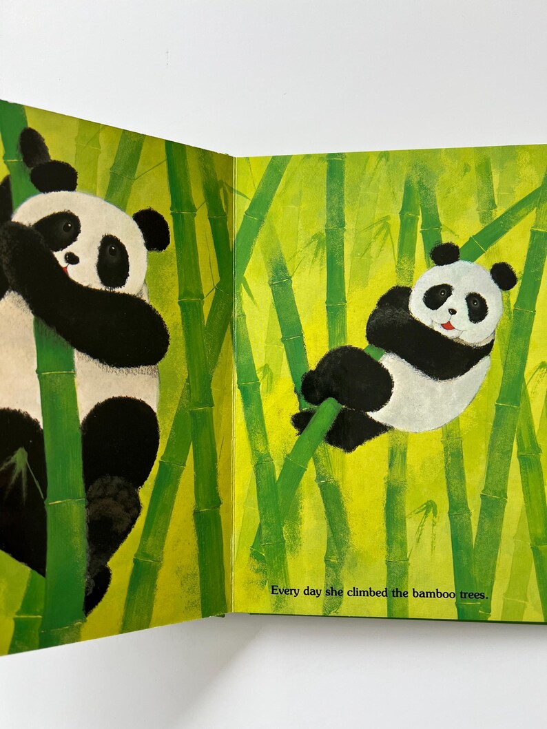 May include: A colourful children's book illustration showing two pandas amongst green bamboo stalks. One panda climbs, the other rests. The text reads, "Every day she climbed the bamboo trees."