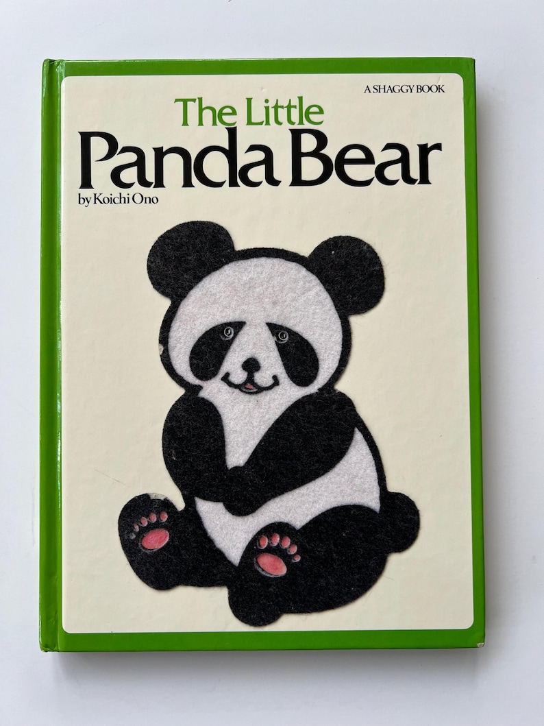 May include: A children's book titled "The Little Panda Bear" by Koichi Ono. The cover shows a felt panda bear illustration in black and white with pink paw pads. The book has a green border and the text "A Shaggy Book".