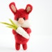 Felted bright red bunny with a daikon raddish