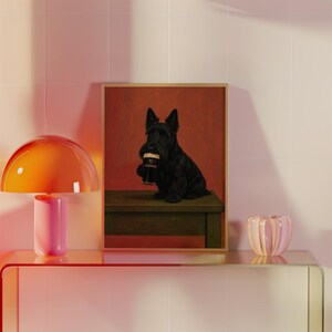 May include: A framed print featuring a black Scottish Terrier dog holding a pint of Guinness. The dog is sitting on a wooden bench against a red background. The Guinness glass is black with a white head.