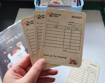 May include: Three blank receipt cards with a paw print logo and the text "Pawtttern Prints". The cards have a light brown background with a grid for writing down items, quantity, and price. The cards also have the text "Receipt" and "Thank you for shopping!" with a cartoon cat illustration.