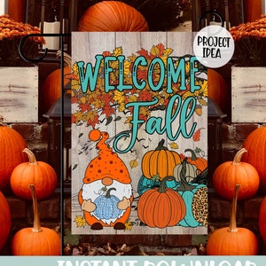 May include: A rectangular garden flag featuring a wood-plank background with the text "WELCOME Fall" in teal. The design includes a gnome wearing an orange hat holding a blue pumpkin, surrounded by various orange and teal pumpkins and autumn leaves.