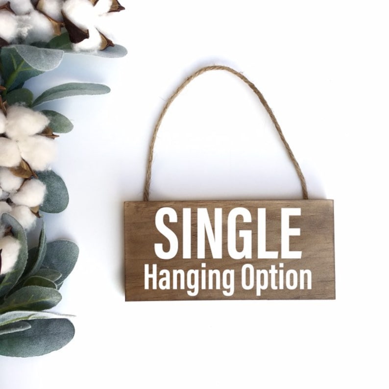 May include: A wooden sign with the text "SINGLE Hanging Option" in white lettering. The sign has a twine loop for hanging.